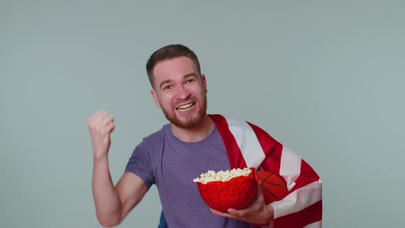 Bearded Young Man Basketball Fan Eating Popcorn Doing Winner Gesture Celebrating Victory Win