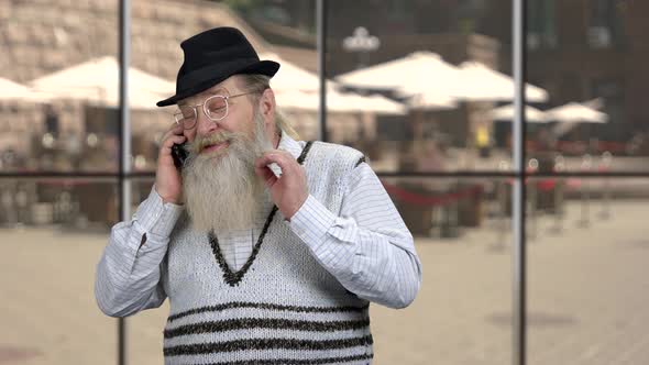 Cheerful Senior Businessman Talking on Phone