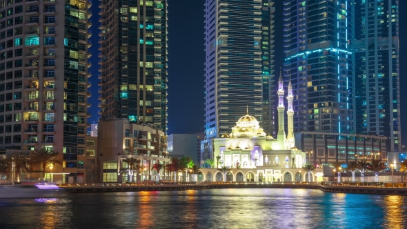 White Mosque Among Skyscrapers in the Harbor Area of Dubai Marina