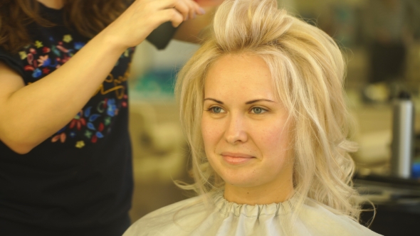 Golden Haired Blonde Girl Doing the Volume Curling By Hairdresser in the Beauty Salon