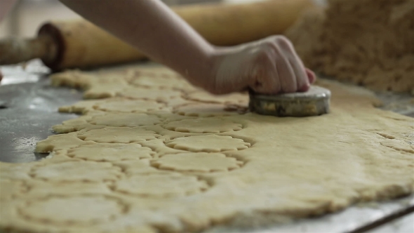 Female Hands Cut the Cookies From the Dough