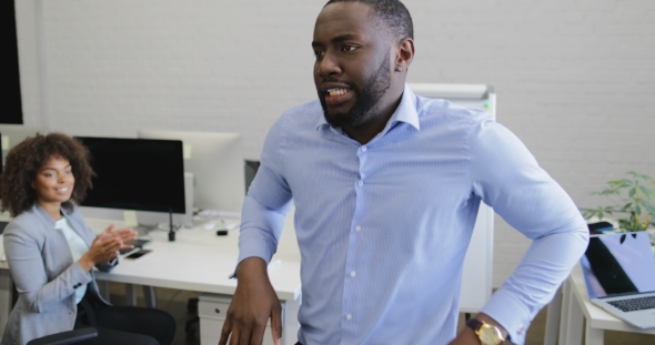 Happy Businessman Dancing Cheering To Successful Deal In Modern Coworking Space With Group Of