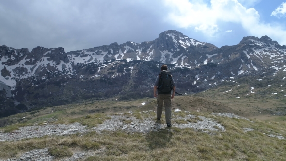 Hiker Goes To the Top and Raises His Arms Up in Victory Gesture