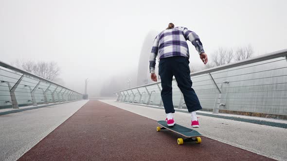 Rear View of a Guy Performing Tricks on a Skateboard