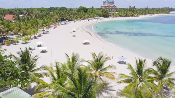 White-sand Beach Resort With Umbrellas At Juan Dolio Beach In Dominican Republic. - aerial