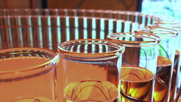 Ring of Laboratory Glass Vials with Yellow Liquid alt