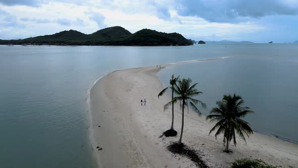 Couple Men and Women Walking on the Beach at the Island Koh Yao Yai Thailand Beach with White Sand