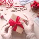 Woman hands in medical gloves wrap Christmas holiday present - VideoHive Item for Sale