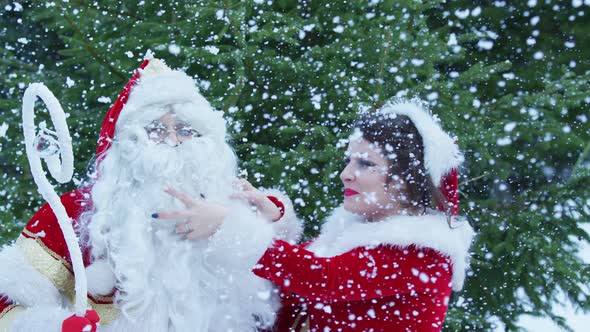 Christmas girl playing with Santa's beard alt