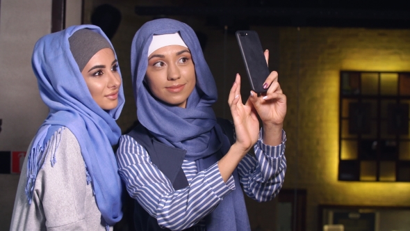Modern Muslim Women Talking and Smiling