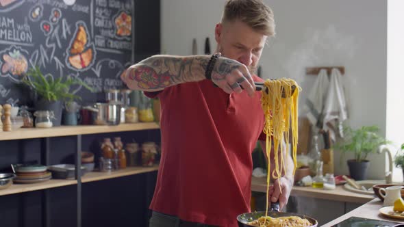 Food Blogger Putting Just Cooked Spaghetti on Plate