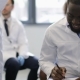 Group Of Scientists Working In Lab Making Notes Over Female Researcher Holding Test Tube - VideoHive Item for Sale