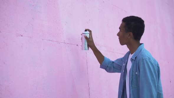 Scared Teenager Drawing Peace Symbol on Wall With Spray Paint, Stop Racism