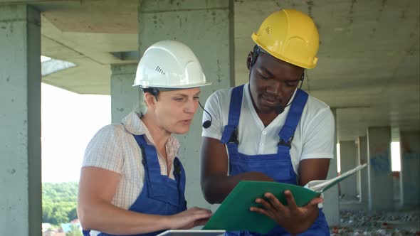 Workers Working on Building Site with Tablet