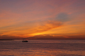 Small fishing boat in the sea at sunset - PhotoDune Item for Sale