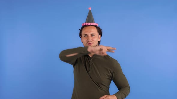 Man in Party Hat and Khaki Colored Shirt