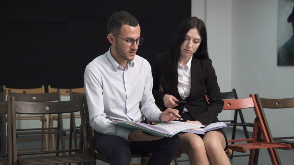 Businessman and Businesswoman Discussing Something