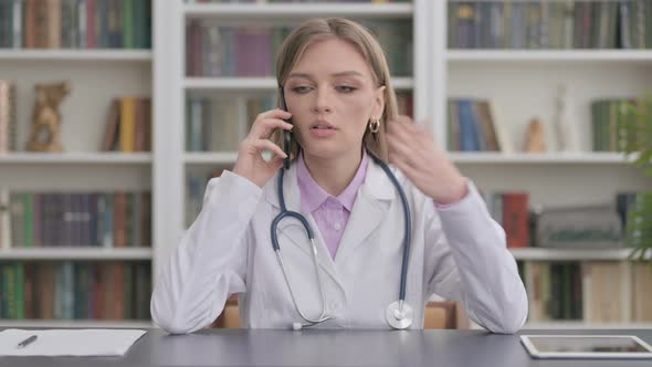 Lady Doctor Talking on Smartphone in Clinic