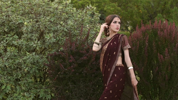 Portrait of Beautiful Girl in Indian Dress in Park