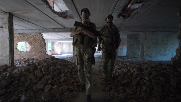 Men with Guns Walking Among Ruins