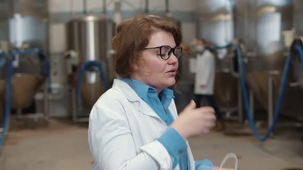 Portrait of Woman Scientist Removing Safety Mask and Coughing in Factory Plant