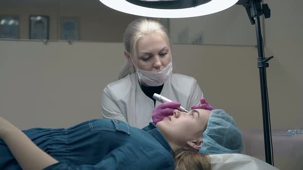 Woman in White Coat and Mask Colours Lady Eyebrow in Black