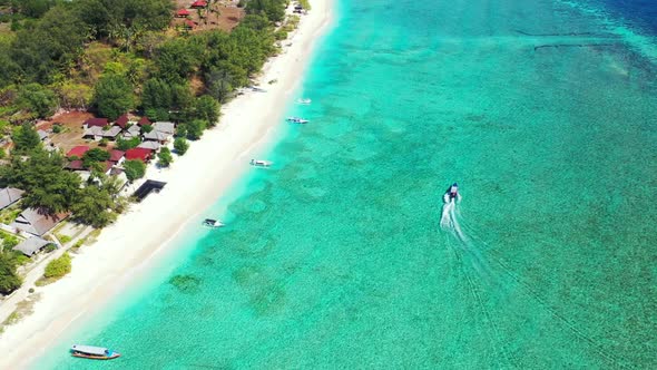 Aerial top view panorama of exotic seashore beach break by turquoise ocean with white sand backgroun