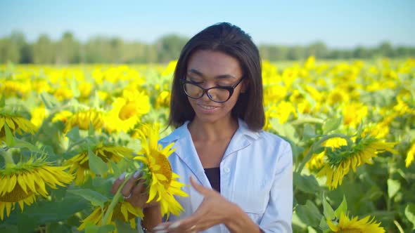 Smiling Woman Agronomist Posing in Sunflower Field