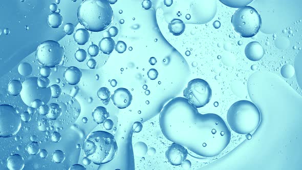 Super Slow Motion Shot of Moving Gel Bubbles on Light Blue Background at 1000Fps alt