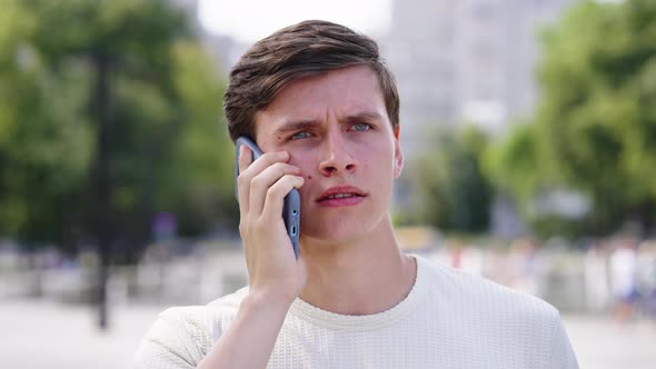 Businessman Talking on Phone and Looking Worried