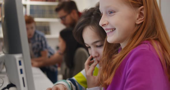 Multiethnic School Kids Using Computer in Classroom at Secondary School