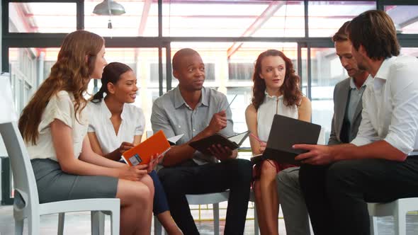 Business executives interacting with each other in meeting