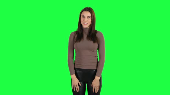 Attractive Girl Smiling and Gesturing with Hands Meaning Denial Saying NO. Green Screen