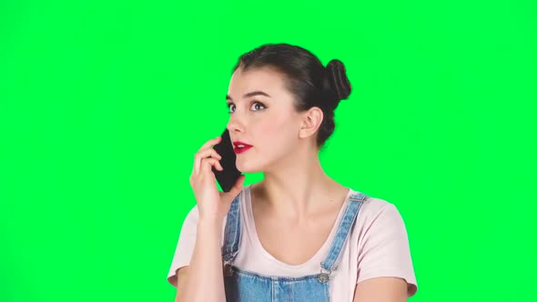 Woman Speaking Via Telephone Looking Boredon Green Screen, Slow Motion