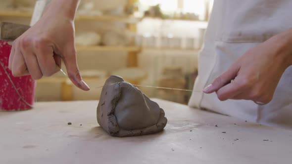 Young female potter working in her studio