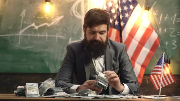 Saving Money. Businessman Offers Purchase. Portrait of Success Business Man with Money Dollar Bills