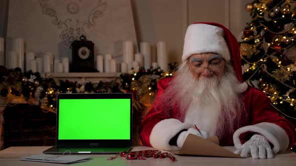 Santa Claus Writes Congratulations Children on New Year Laptop Green Screen