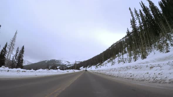 Time-lapse. POV point of view - Driving through Swan Mountain in the Winter.