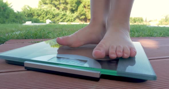 Child Standing to Bathroom Scales