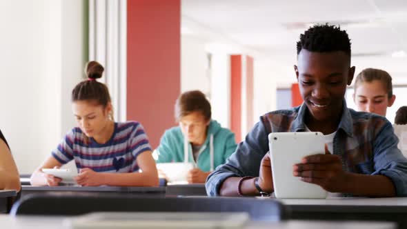 Students using digital tablets in classroom