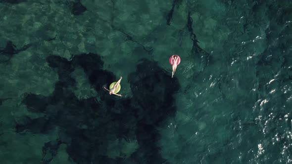 Aerial drone footage of woman having fun on turquoise waves, relaxed and chill vacation holiday