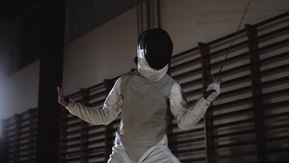 Fencers Duelling Back and Forth with Foils