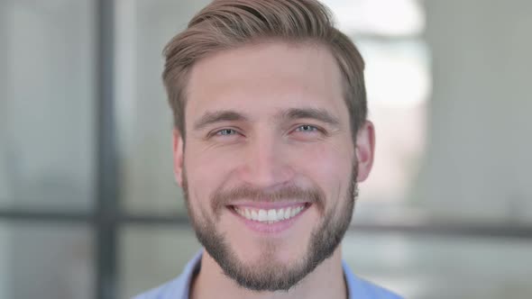 Close Up of Face of Happy Creative Man Smiling at Camera