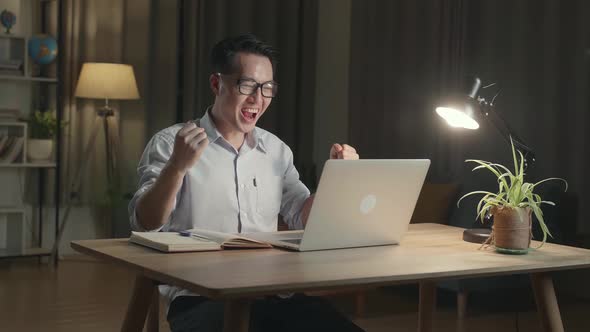 Asia Businessman Celebrating While Working From Home At Living Room At Night