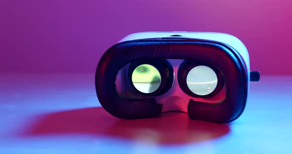 Virtual reality device with video playing inside under purple lighting