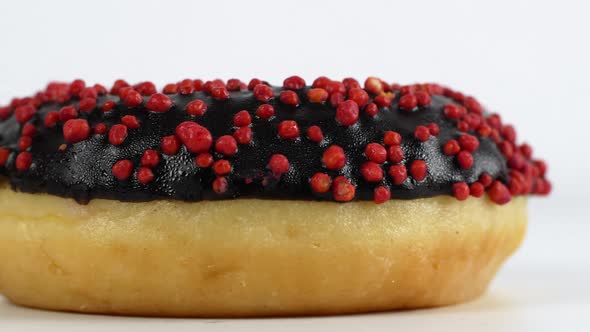 Close-up slider motion donuts. 4k closeup of delicious sweet multicolored donuts on colorful back