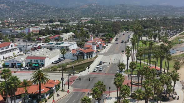 aerial drone panning across a traffic light intersection as cars wait for the light to turn green in