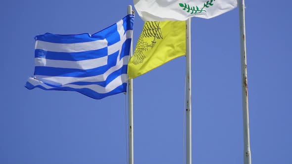 Fluttering in Wind Flags of Cyprus and Greece Against Blue Sky