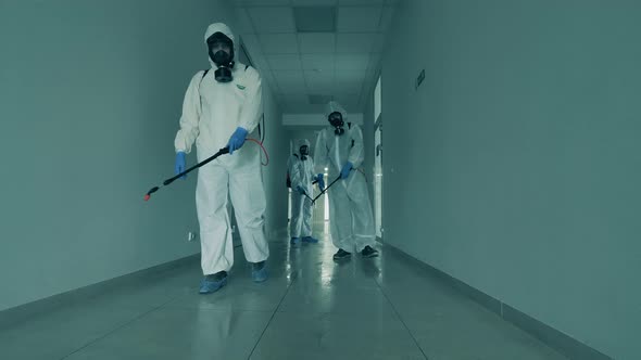 Male Workers Disinfect a Hallway of an Office Building