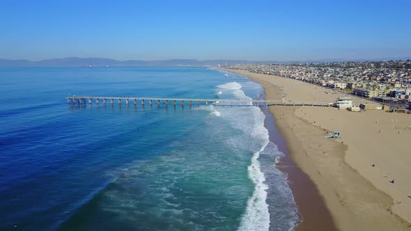 Aerial drone uav view of a pier over the beach and ocean.